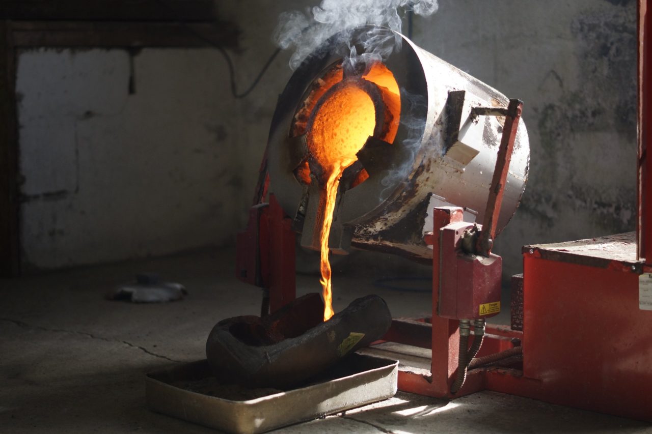 An image of a smelter pouring an ingot